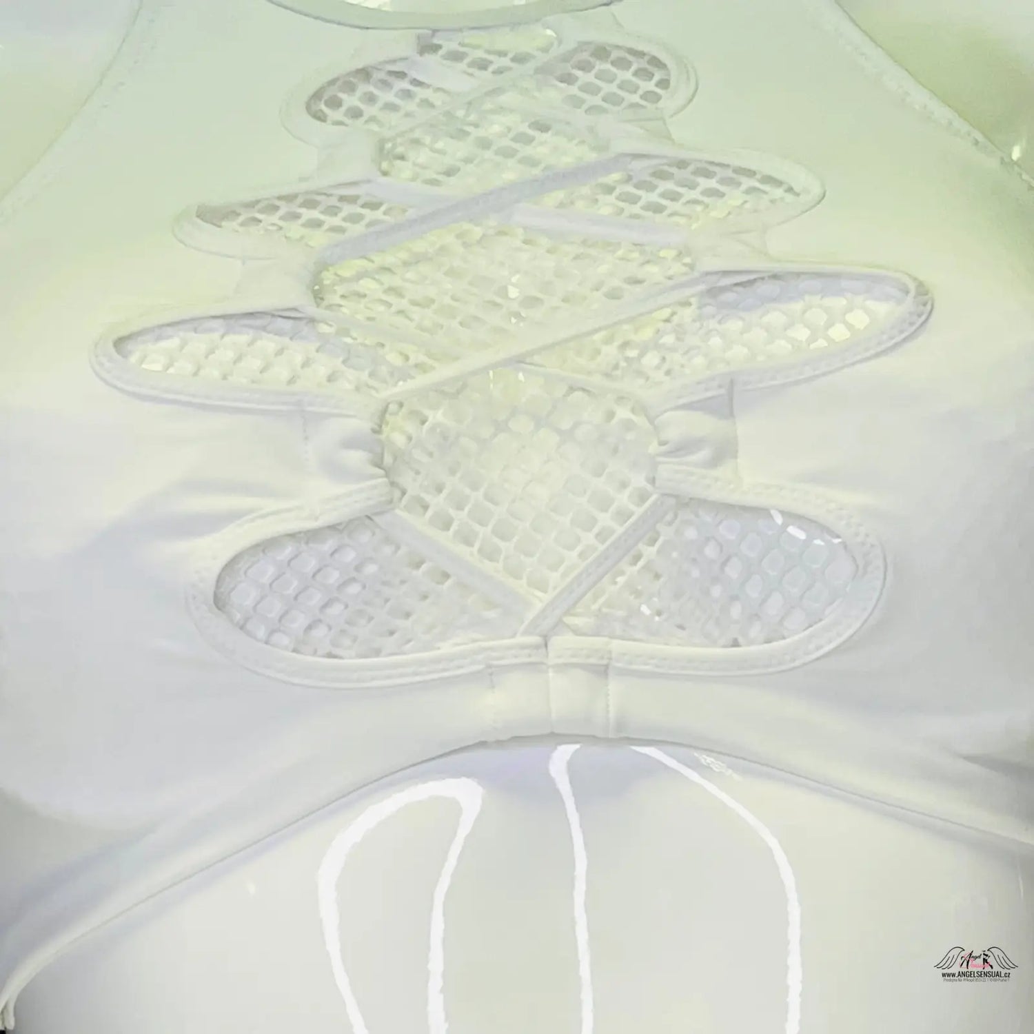 Waffle-textured butterfly or flower shape embossed on light surface, plavek hatty style