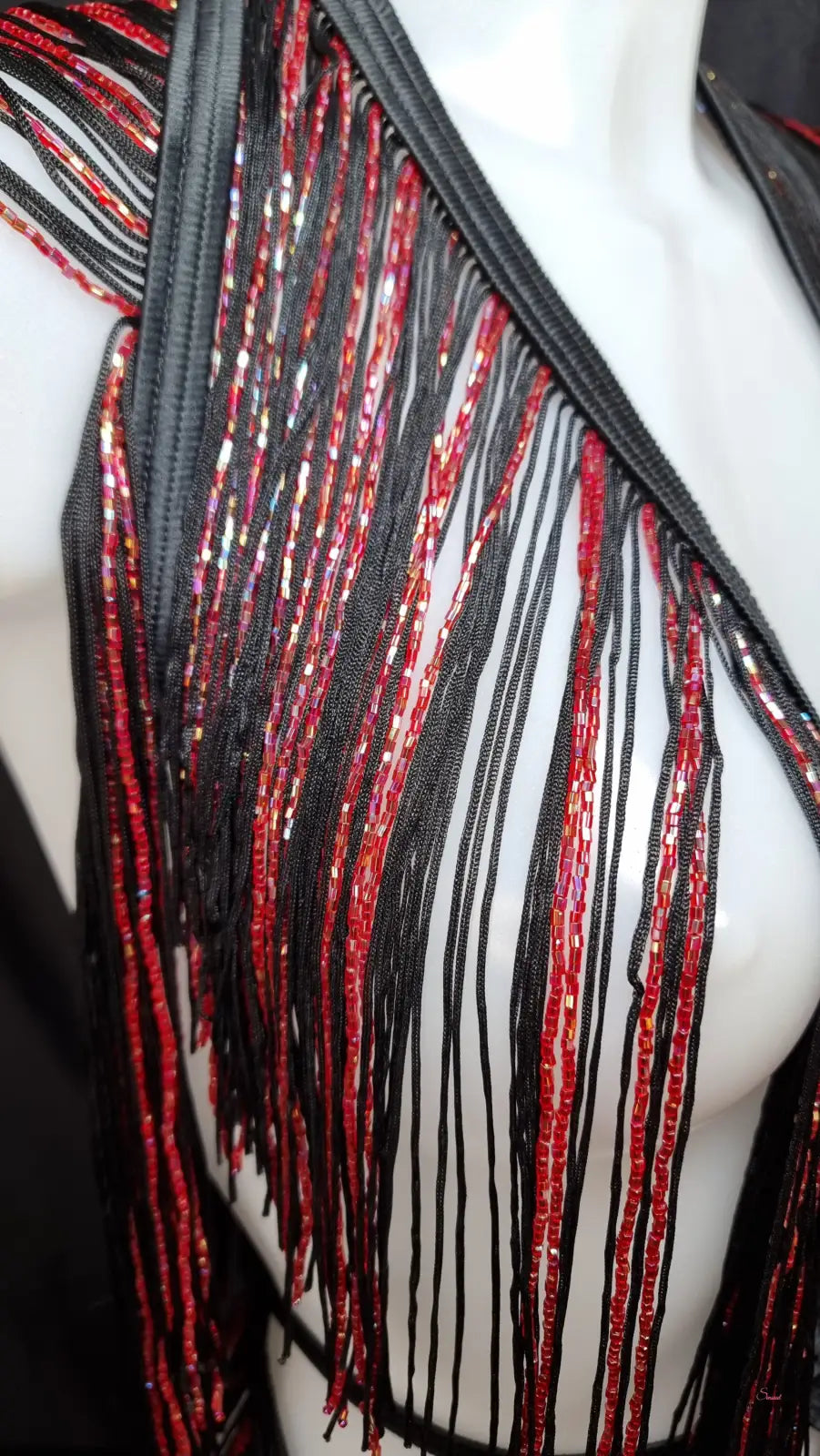Red and black beaded fringe trim on a white mannequin in Agent Provocateur Korálkový Playsuit Inga