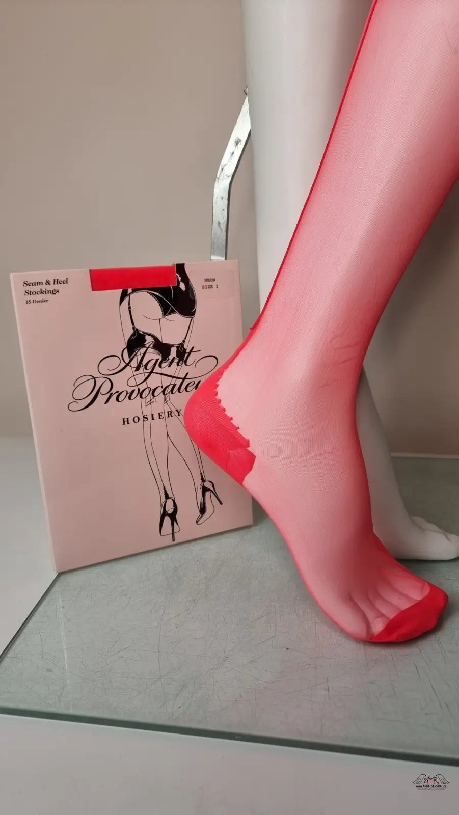 Red hosiery on a mannequin showcasing Agent Provocateur Neon Stocking 15 Denier
