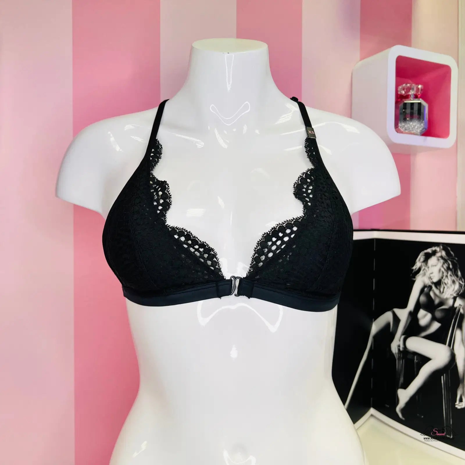 Arafovaný mannequin s krajkovou braletkou Victoria’s Secret na růžové pruhované zdi