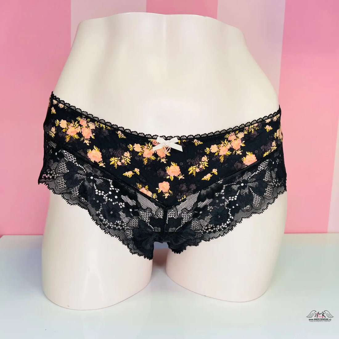 Black lace-trimmed floral print underwear displayed on a mannequin form, elegant luxusní kalhotky