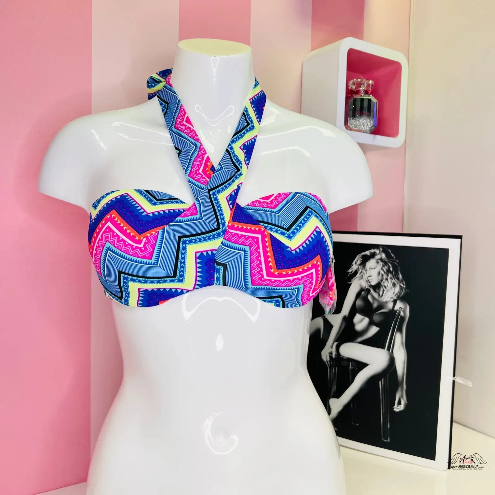 Colorful zigzag-patterned halter bikini top na bílém modelu, elegantní modro-bílý horní díl