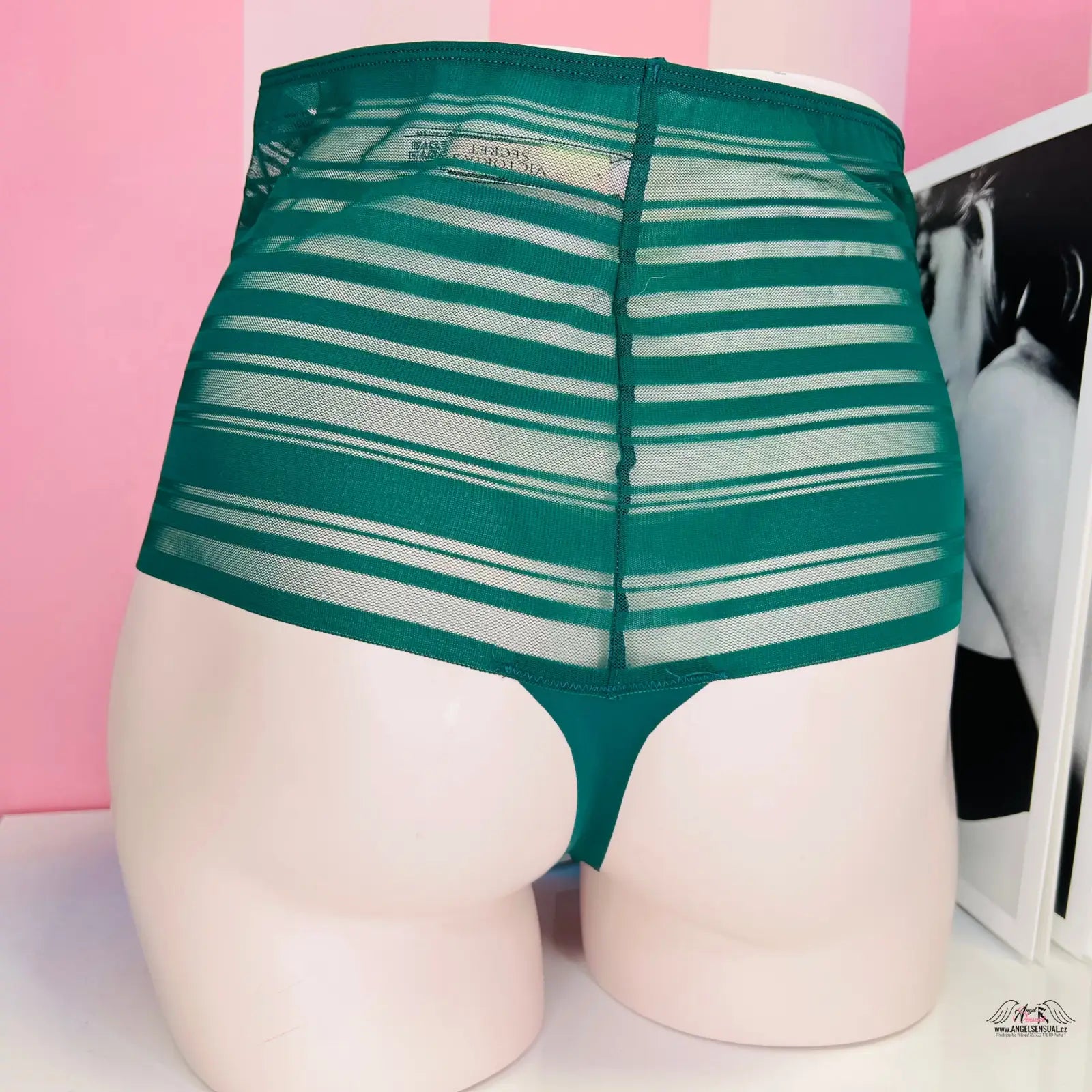 Žena v luxusní lehce průsvitné tanga s velmi vysokým pasem na bílém pozadí