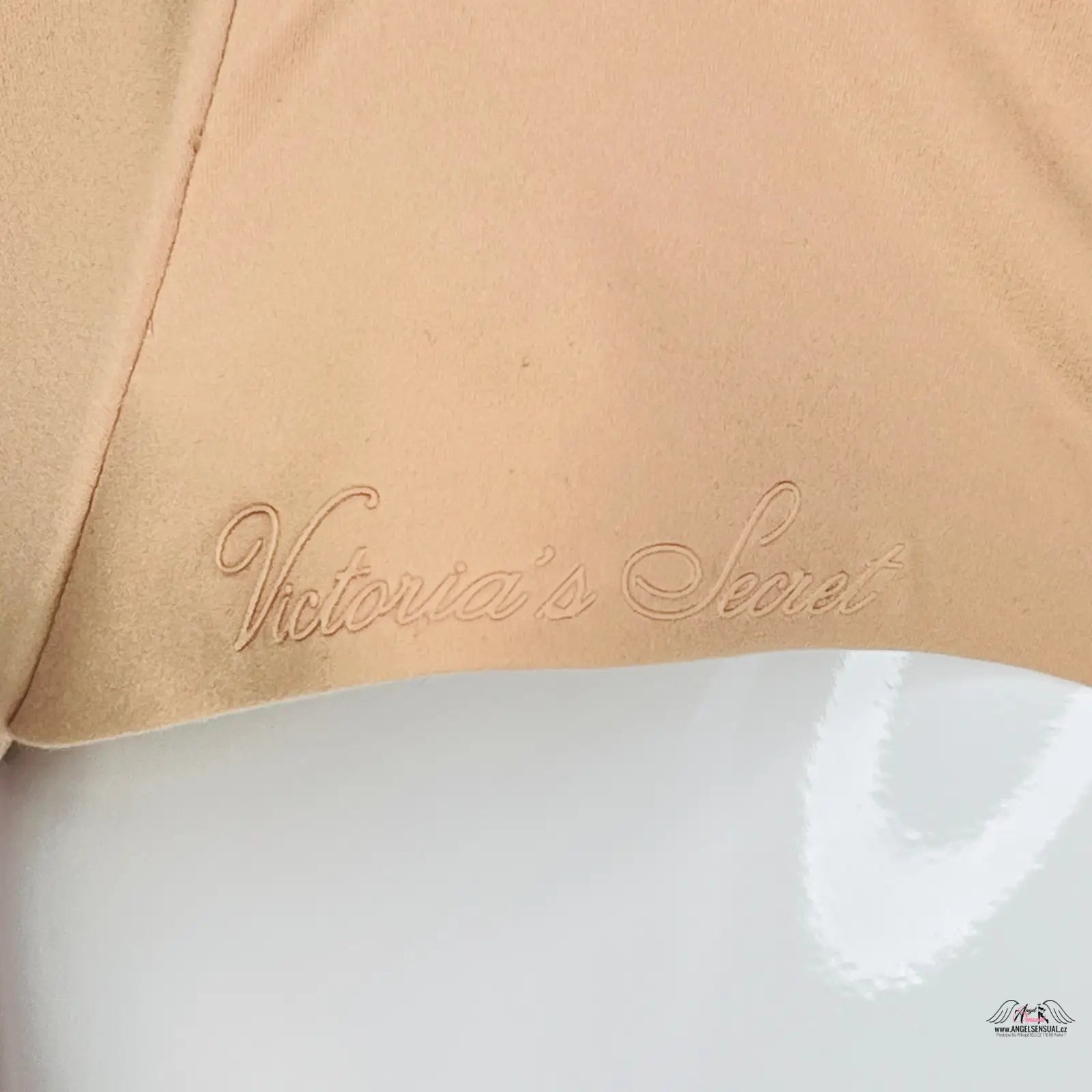 Victoria’s Secret logo embroidered in beige on beige fabric, elegant angel sensual design