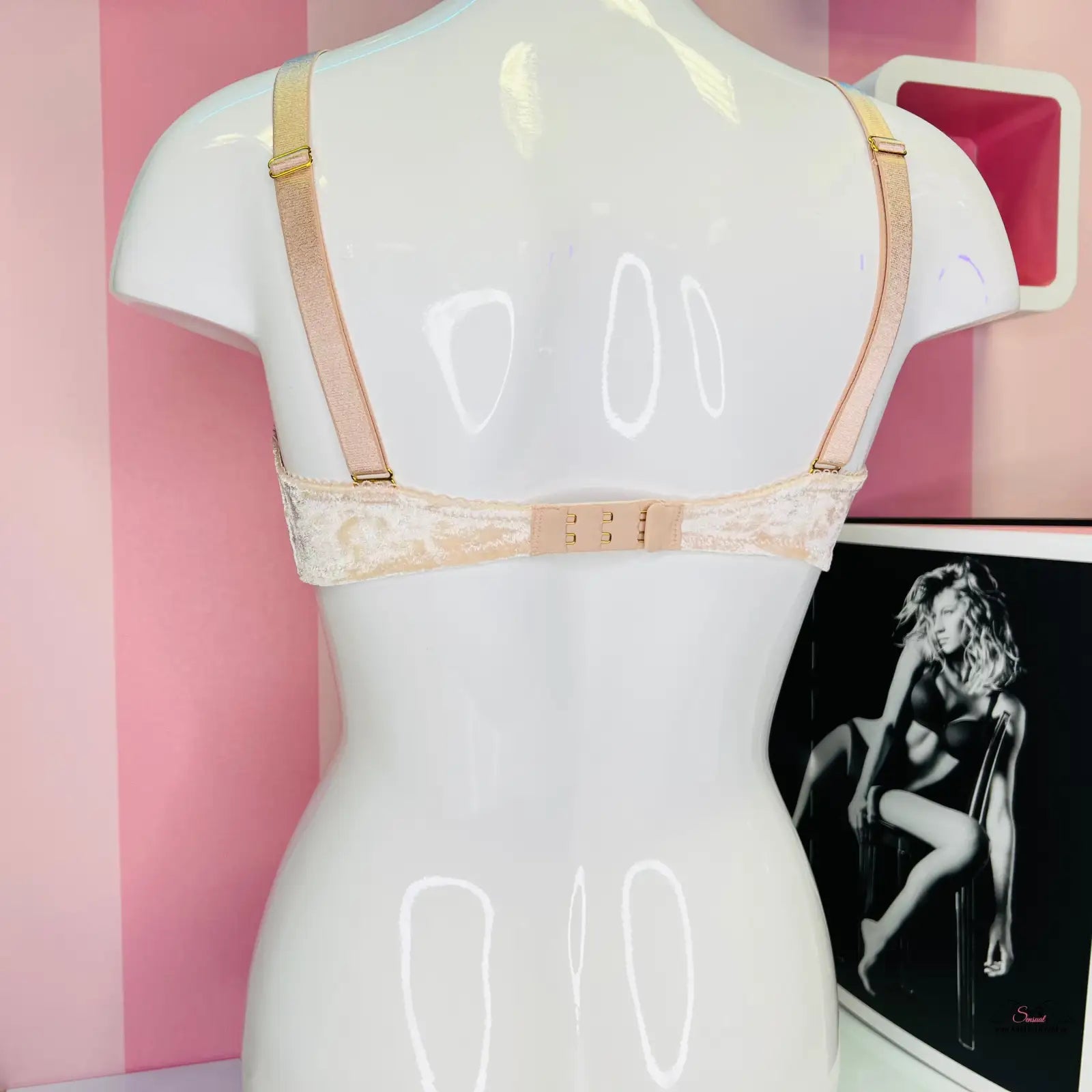 Mannequin with a pink gold suede bra and an image of a woman in Agent Provocateur