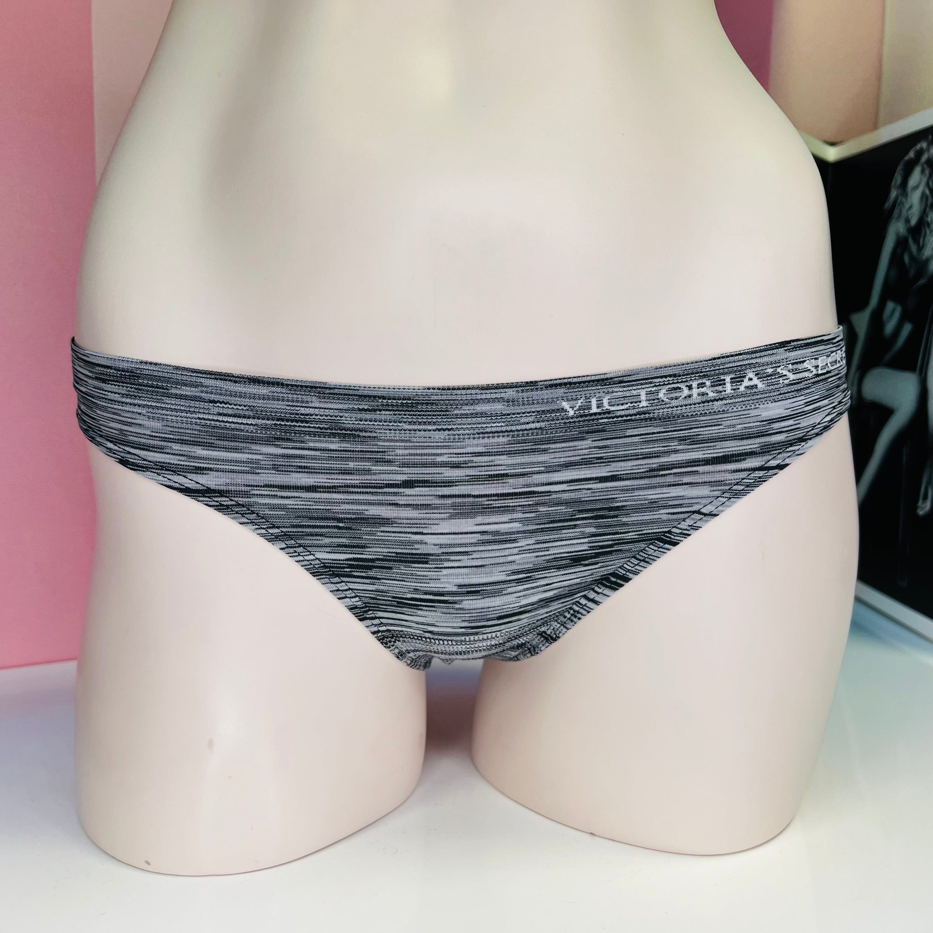 Žíhané kalhotky Victoria’s Secret na levé straně s pruhy šedé a bílé barvy