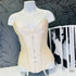 Mannequin na stole s obrázkem ženy a Agent Provocateur Korzet Classic Cream