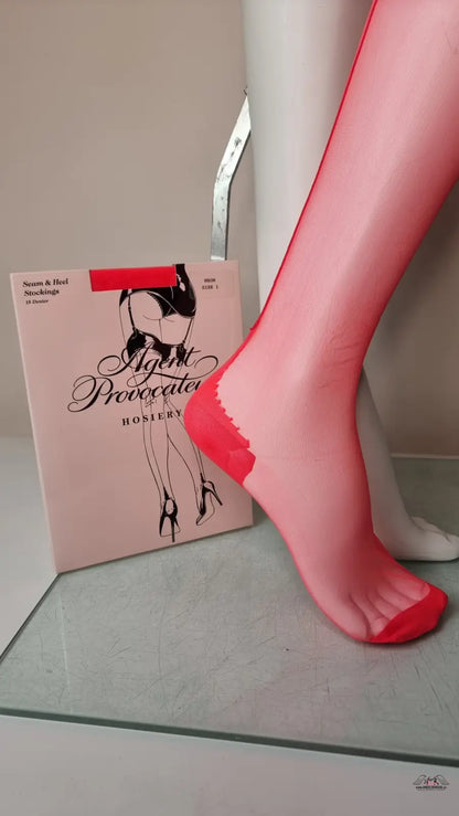 Red hosiery on a mannequin showcasing Agent Provocateur Neon Stocking 15 Denier