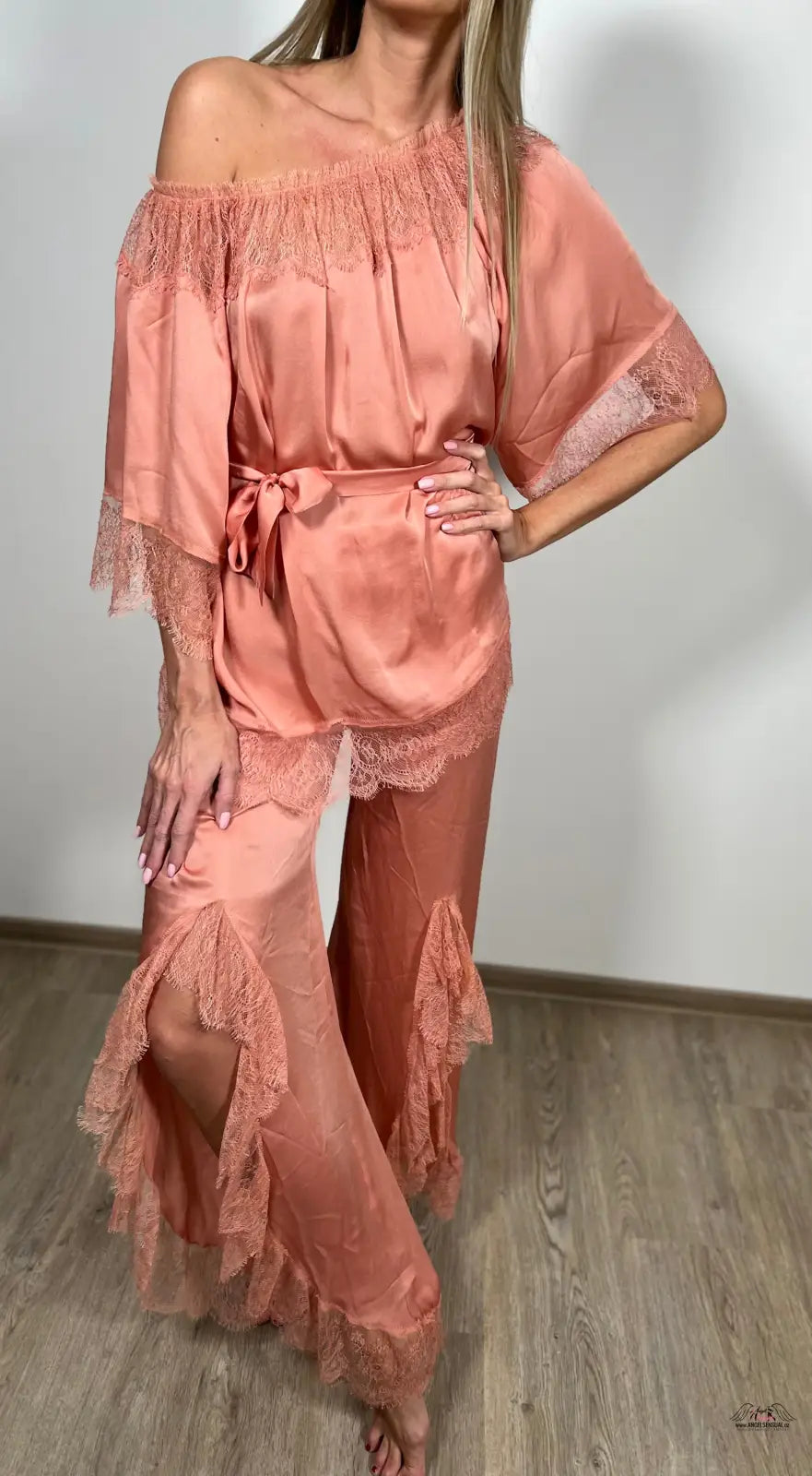 Žena v růžovém off-shoulder top a kalhotách na Agent Provocateur Racquel Peach pyžamovém setu