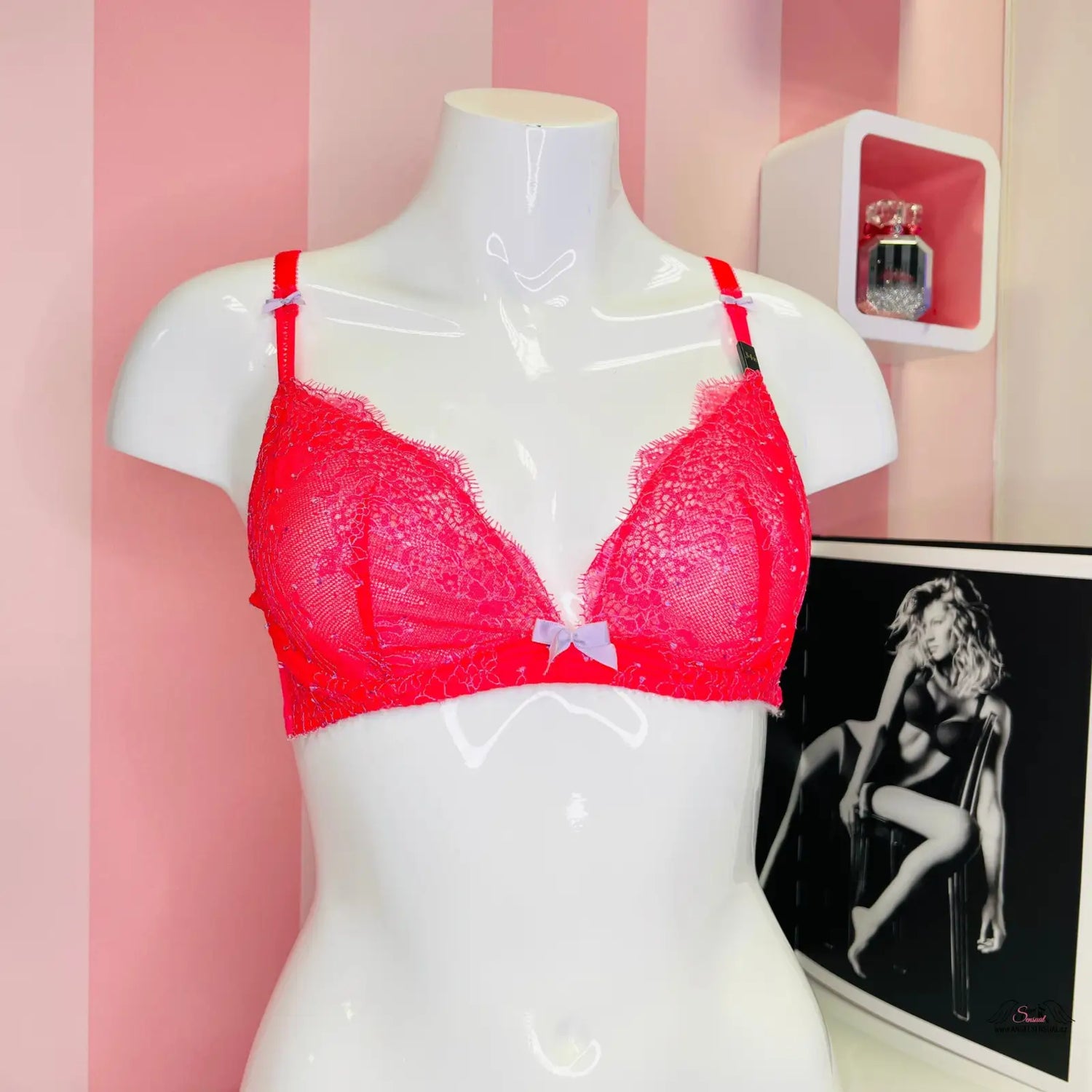Red bra displayed with a black and white photo of a woman from Braletka collection