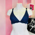 Arafed mannequin in a blue bra against a pink striped wall showcasing Braletka