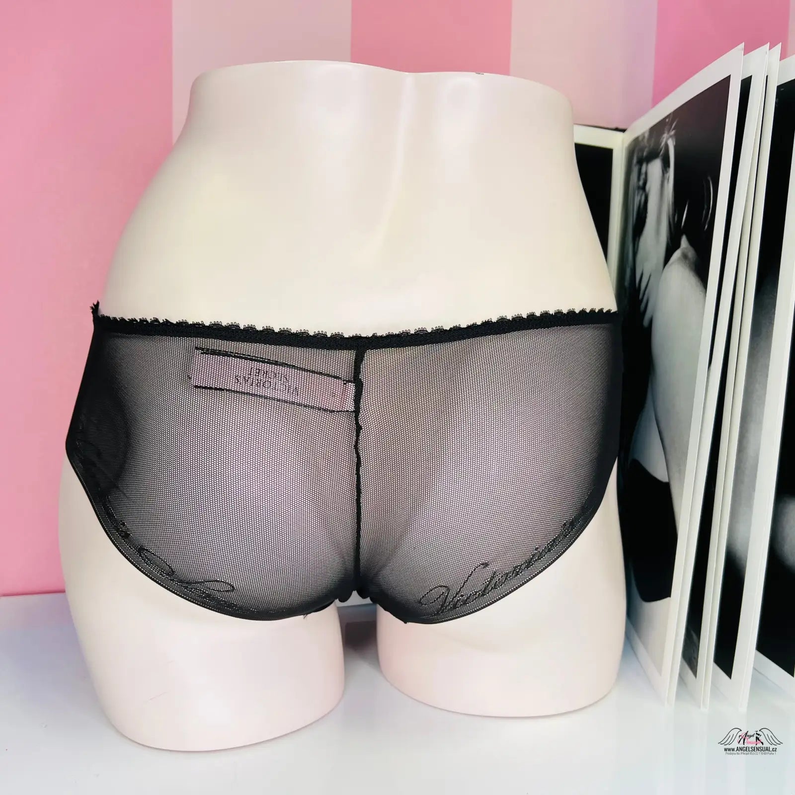 Černé průsvitné kalhotky na bílém manekýnu s elegantním designem