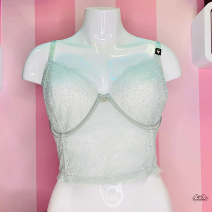 Bílý krajkový bralet s mátově zeleným lemováním na torzu manekýna