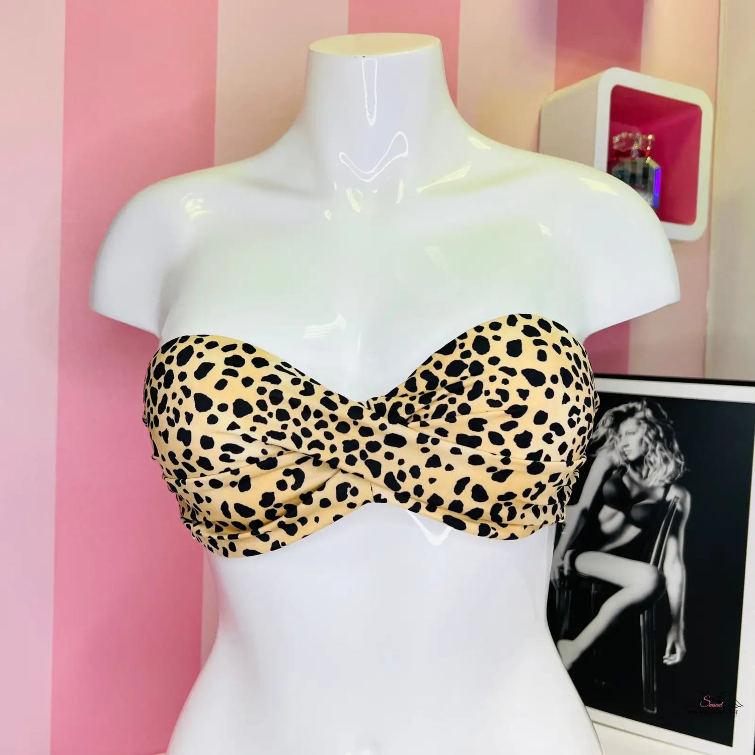 Strapless leopard print bandeau bikini top on white mannequin for summer elegance