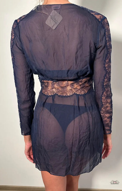 Sheer navy blue dress with lace sleeves and waistband, showcased from the back