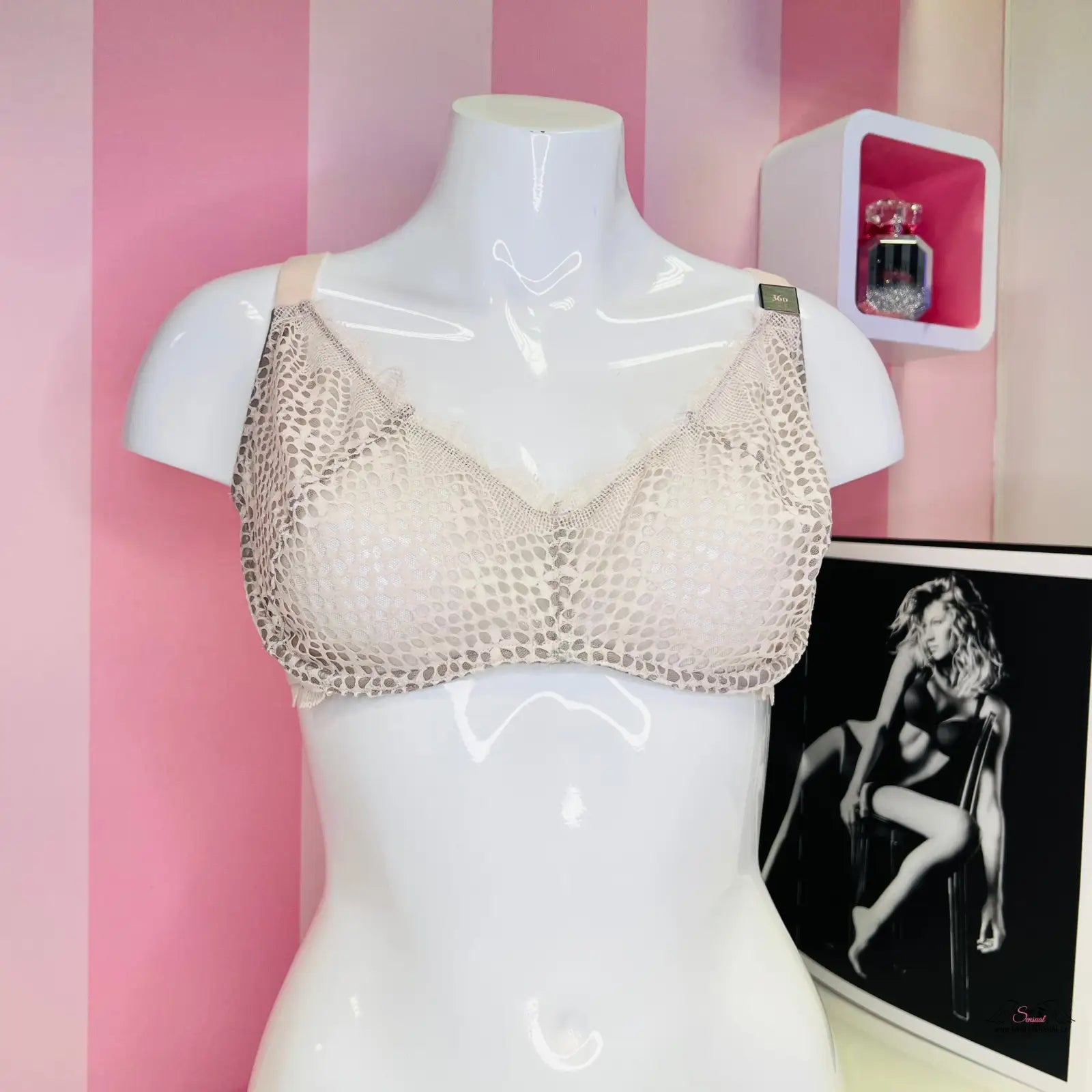 Araffed mannequin with a bra and a picture of a woman in Victoria’s Secret lingerie