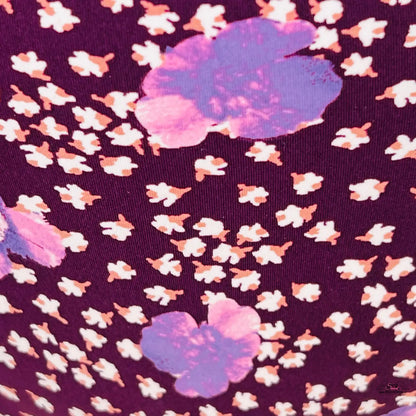 Floral pattern with white blossoms and purple clouds on dark purple background