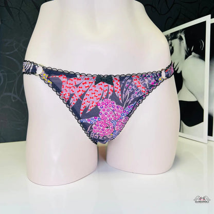 Floral print thong with black lace trim from Riva Kalhotky for stylish lingerie elegance
