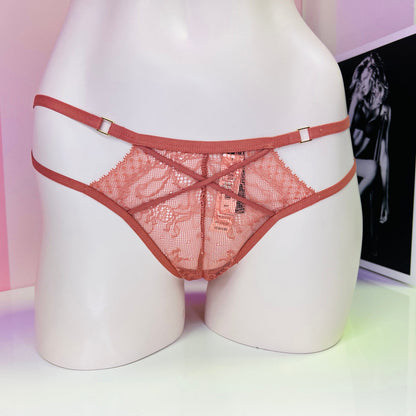 Pink lace and mesh panties on mannequin form for Victoria’s Secret Strappy Tanga