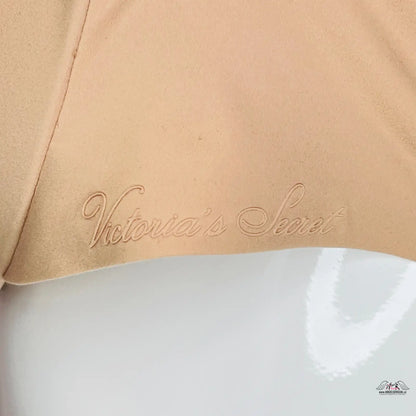 Victoria’s Secret logo embroidered in beige on beige fabric, elegant angel sensual design